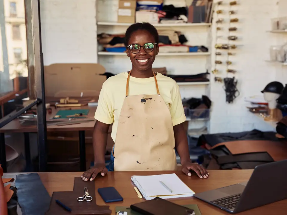A leather workshop owner at her workbench