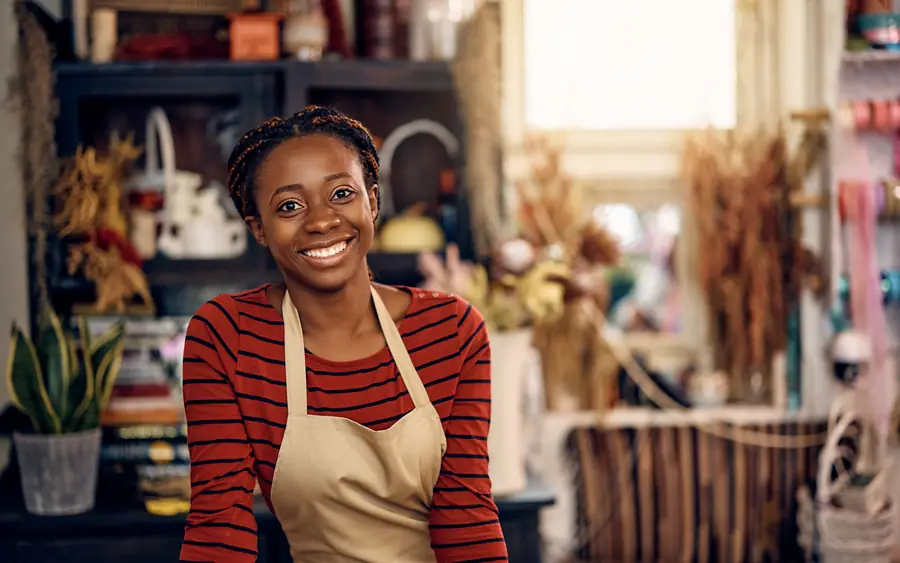 A shop owner smiling in her craft shop