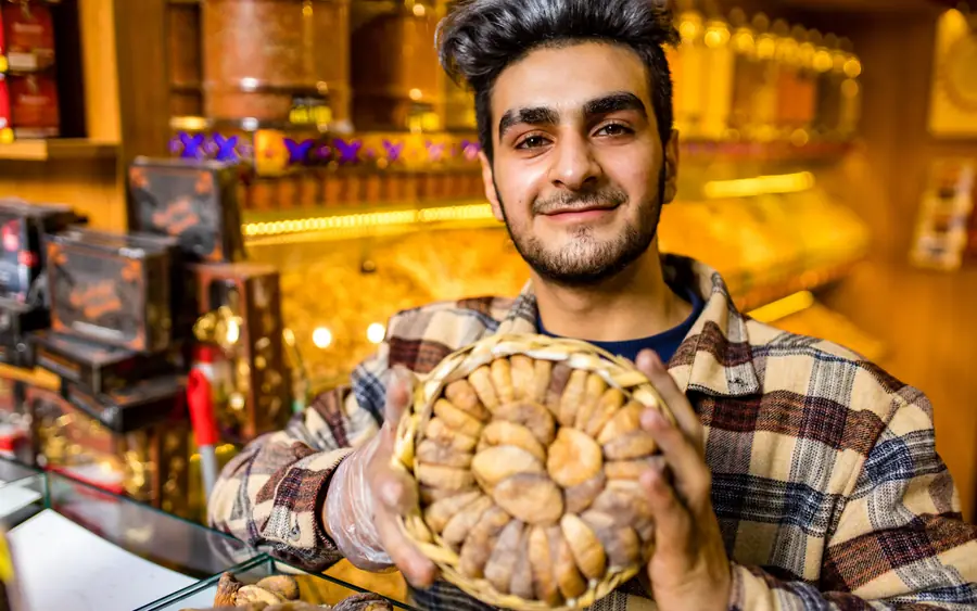 A baker holding a tray of bread