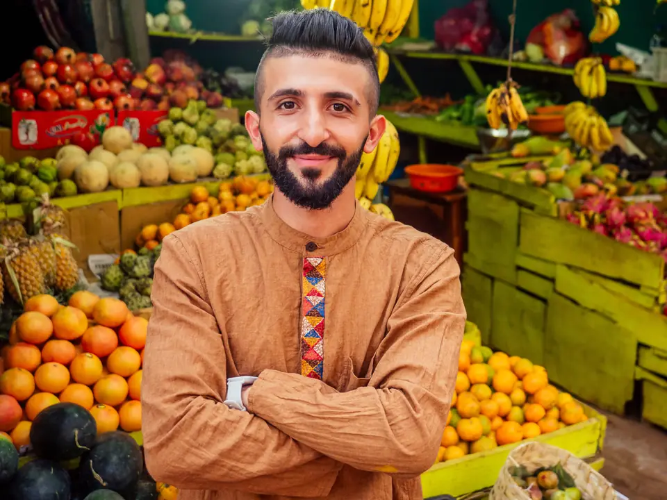 A greengrocer among his fruit crates
