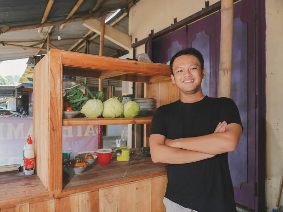A stallholder beside his fresh produce