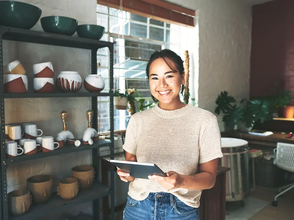 A shop owner with a tablet in her homeware shop